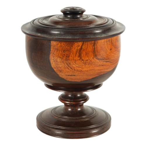 612 - A 19TH CENTURY LIGNUM VITAE TREEN WARE BOWL AND COVER of footed form with detailed ring turned knopp... 