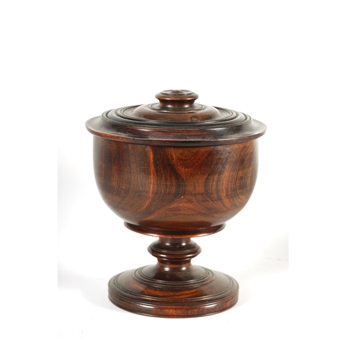 612 - A 19TH CENTURY LIGNUM VITAE TREEN WARE BOWL AND COVER of footed form with detailed ring turned knopp... 