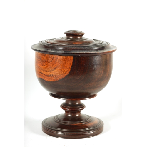 612 - A 19TH CENTURY LIGNUM VITAE TREEN WARE BOWL AND COVER of footed form with detailed ring turned knopp... 