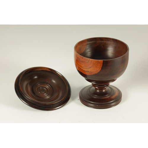 612 - A 19TH CENTURY LIGNUM VITAE TREEN WARE BOWL AND COVER of footed form with detailed ring turned knopp... 