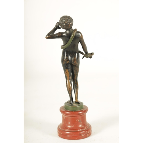 626 - A 19TH CENTURY CONTINENTAL BRONZE STANDING FEMALE FIGURE modelled as a snake charmer; mounted on a c... 