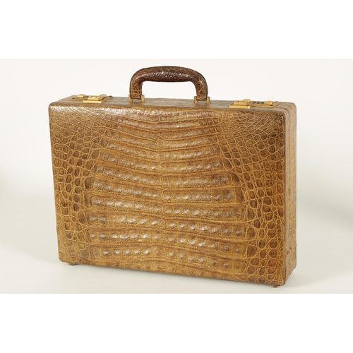 632 - A GOOD VINTAGE CROCODILE BRIEFCASE with fitted document slots to the interior and double gilt brass ... 