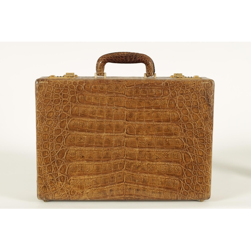 632 - A GOOD VINTAGE CROCODILE BRIEFCASE with fitted document slots to the interior and double gilt brass ... 