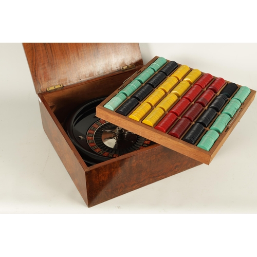 646 - AN EARLY 20TH CENTURY ROULETTE WHEEL AND CHIPS IN BURR WALNUT CASE the box with crossbanded edge and... 