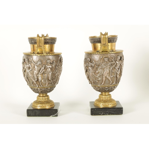 647 - A PAIR OF LATE 19TH CENTURY BRONZE AND SILVERED BRONZE GRAND TOUR URNS with stylised handles and sho... 