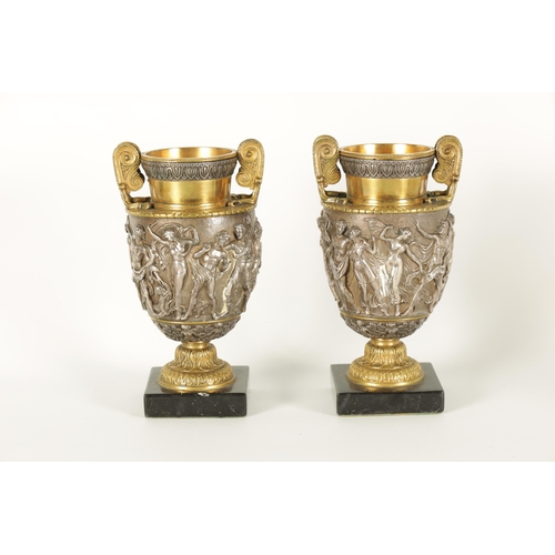 647 - A PAIR OF LATE 19TH CENTURY BRONZE AND SILVERED BRONZE GRAND TOUR URNS with stylised handles and sho... 