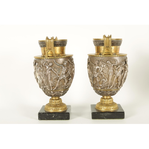 647 - A PAIR OF LATE 19TH CENTURY BRONZE AND SILVERED BRONZE GRAND TOUR URNS with stylised handles and sho... 