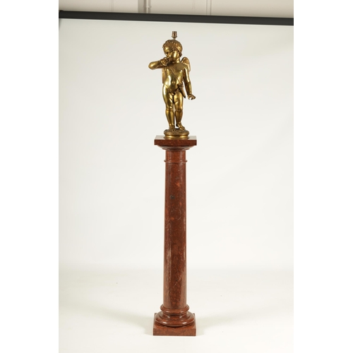 649 - AN EARLY 20TH CENTURY GILT BRONZE FIGURAL LAMP ON ROUGE MARBLE PEDESTAL the lamp modelled as Cupid s... 