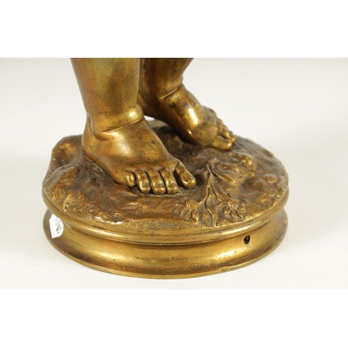 649 - AN EARLY 20TH CENTURY GILT BRONZE FIGURAL LAMP ON ROUGE MARBLE PEDESTAL the lamp modelled as Cupid s... 