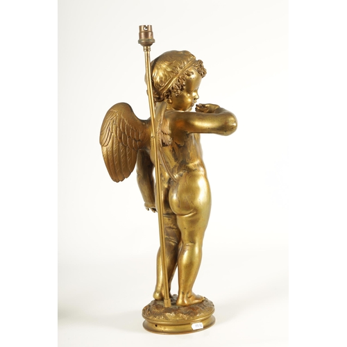 649 - AN EARLY 20TH CENTURY GILT BRONZE FIGURAL LAMP ON ROUGE MARBLE PEDESTAL the lamp modelled as Cupid s... 