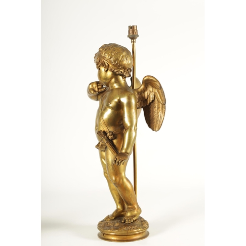 649 - AN EARLY 20TH CENTURY GILT BRONZE FIGURAL LAMP ON ROUGE MARBLE PEDESTAL the lamp modelled as Cupid s... 