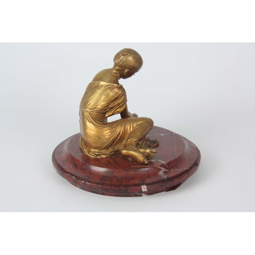 653 - AN EARLY 20TH CENTURY CLASSICAL FIGURAL GILT BRONZE SCULPTURE depicting a young girl mounted on a ro... 