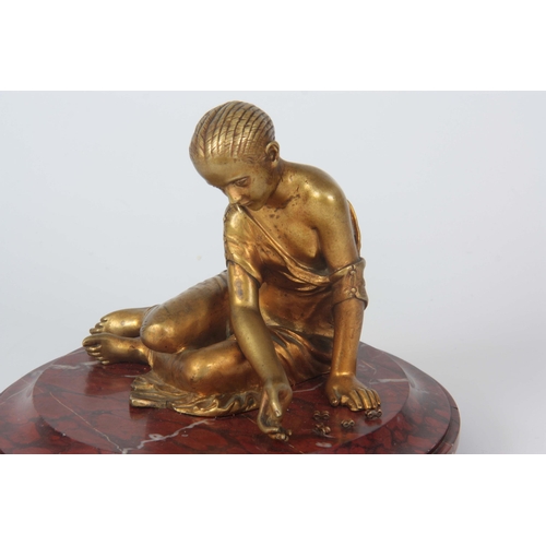 653 - AN EARLY 20TH CENTURY CLASSICAL FIGURAL GILT BRONZE SCULPTURE depicting a young girl mounted on a ro... 