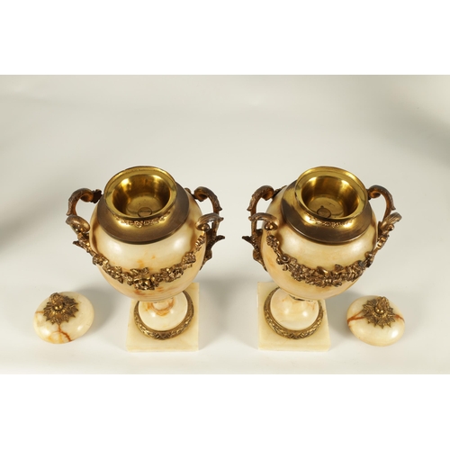 654 - A PAIR OF 19TH CENTURY FRENCH SIENA MARBLE AND ORMOLU MOUNTED CASSOLETTES the covered urn shaped bod... 