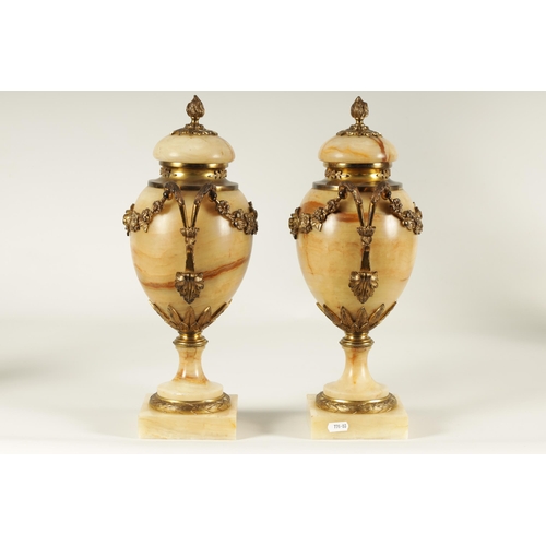 654 - A PAIR OF 19TH CENTURY FRENCH SIENA MARBLE AND ORMOLU MOUNTED CASSOLETTES the covered urn shaped bod... 