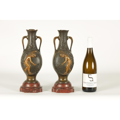 667 - E PROVOST A PAIR OF LATE 19TH CENTURY BRONZE TWO HANDLED FLATTENED OVOID VASES ON ROUGE MARBLE BASES... 