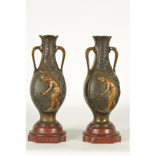 667 - E PROVOST A PAIR OF LATE 19TH CENTURY BRONZE TWO HANDLED FLATTENED OVOID VASES ON ROUGE MARBLE BASES... 