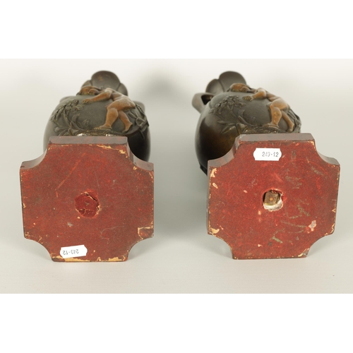 667 - E PROVOST A PAIR OF LATE 19TH CENTURY BRONZE TWO HANDLED FLATTENED OVOID VASES ON ROUGE MARBLE BASES... 