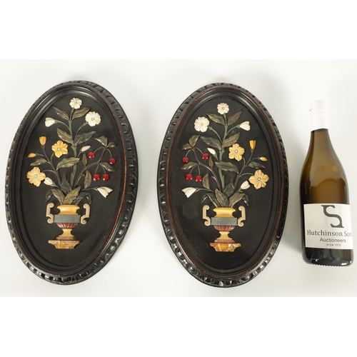 677 - A PAIR OF 19TH CENTURY ITALIAN BLACK SLATE AND PIETRA DURA SLENDER OVAL HANGING PLAQUES decorated in... 