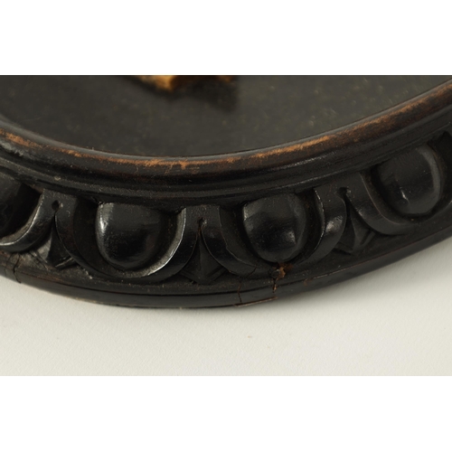 677 - A PAIR OF 19TH CENTURY ITALIAN BLACK SLATE AND PIETRA DURA SLENDER OVAL HANGING PLAQUES decorated in... 