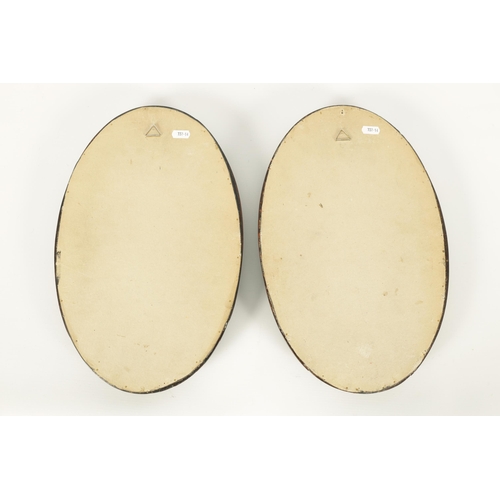 677 - A PAIR OF 19TH CENTURY ITALIAN BLACK SLATE AND PIETRA DURA SLENDER OVAL HANGING PLAQUES decorated in... 