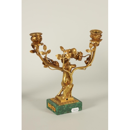 678 - A PAIR OF EARLY 20TH CENTURY TWO BRANCH GILT BRONZE AND MALACHITE CANDELABRA with floral branchwork ... 