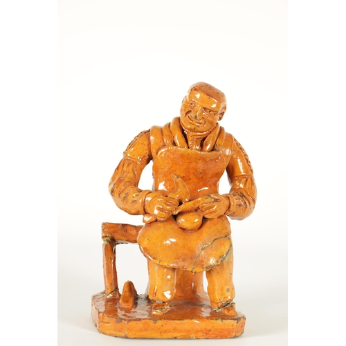 68 - A MID 19TH CENTURY PILL POTTERY WELSH REDWARE GLAZED EARTHENWARE FIGURE modelled as a seated cobbler... 