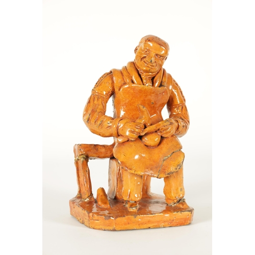 68 - A MID 19TH CENTURY PILL POTTERY WELSH REDWARE GLAZED EARTHENWARE FIGURE modelled as a seated cobbler... 