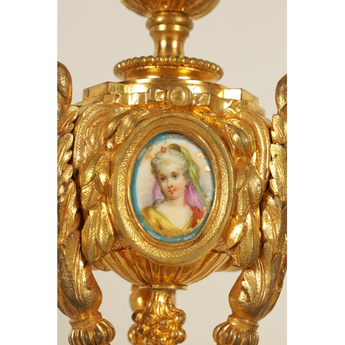 688 - A PAIR OF 19TH CENTURY FRENCH ORMOLU AND PORCELAIN PANELLED CANDLESTICKS the bodies inset with oval ... 