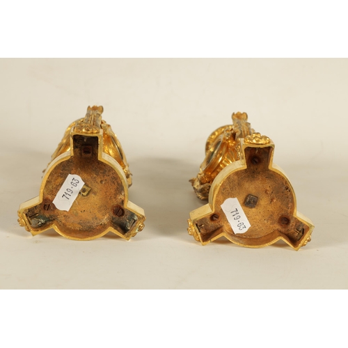 688 - A PAIR OF 19TH CENTURY FRENCH ORMOLU AND PORCELAIN PANELLED CANDLESTICKS the bodies inset with oval ... 