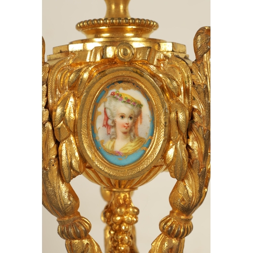 688 - A PAIR OF 19TH CENTURY FRENCH ORMOLU AND PORCELAIN PANELLED CANDLESTICKS the bodies inset with oval ... 