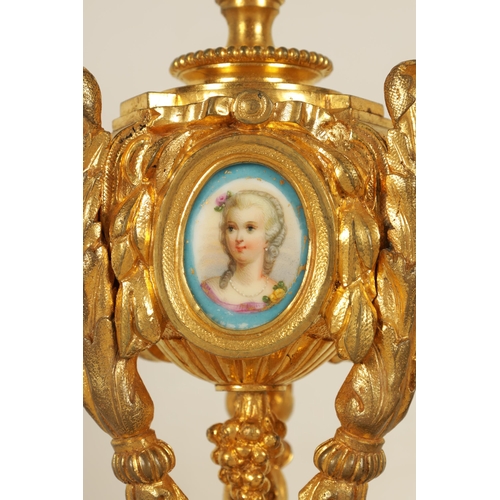 688 - A PAIR OF 19TH CENTURY FRENCH ORMOLU AND PORCELAIN PANELLED CANDLESTICKS the bodies inset with oval ... 