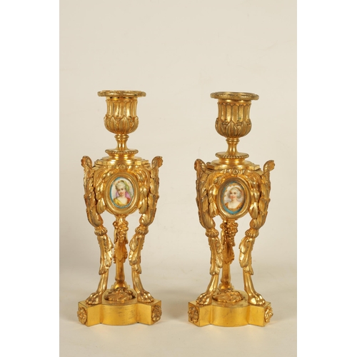 688 - A PAIR OF 19TH CENTURY FRENCH ORMOLU AND PORCELAIN PANELLED CANDLESTICKS the bodies inset with oval ... 