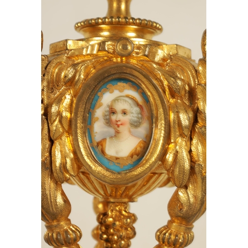 688 - A PAIR OF 19TH CENTURY FRENCH ORMOLU AND PORCELAIN PANELLED CANDLESTICKS the bodies inset with oval ... 