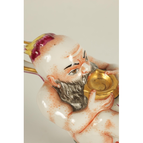 69 - A 19TH CENTURY ITALIAN CAPODIMONTE PORCELAIN INKWELL modelled as a genie and lamp, gilt and hand pai... 