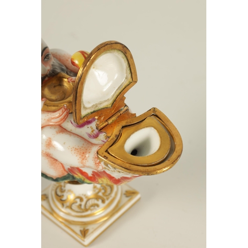 69 - A 19TH CENTURY ITALIAN CAPODIMONTE PORCELAIN INKWELL modelled as a genie and lamp, gilt and hand pai... 