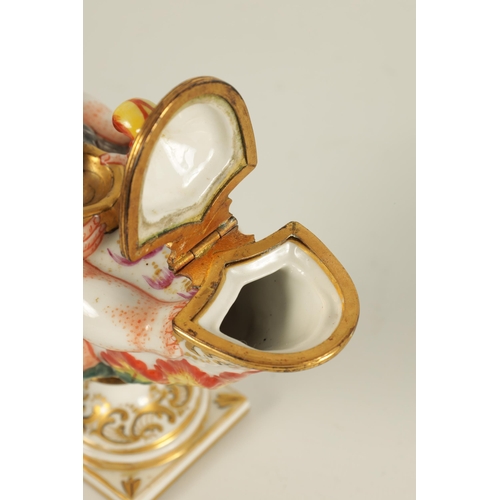 69 - A 19TH CENTURY ITALIAN CAPODIMONTE PORCELAIN INKWELL modelled as a genie and lamp, gilt and hand pai... 