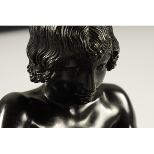 695 - A LATE 19TH CENTURY ITALIAN PATINATED BRONZE SCULPTURE modelled as a boy removing a thorn from his f... 