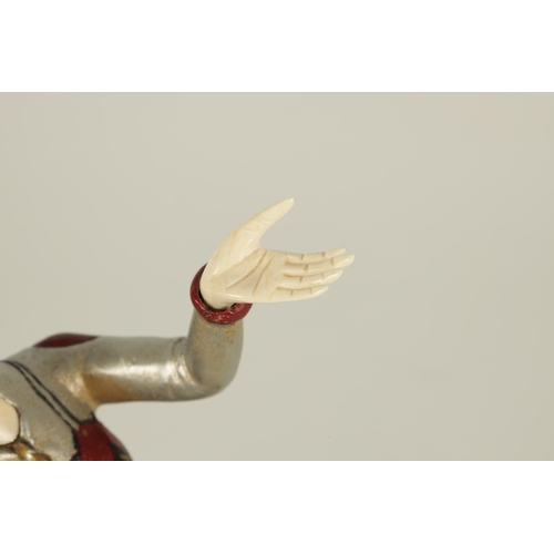 704 - AN ART DECO COLD PAINTED BRONZE AND IVORY FIGURE OF A FEMALE JESTER dancing and mounted on a stepped... 