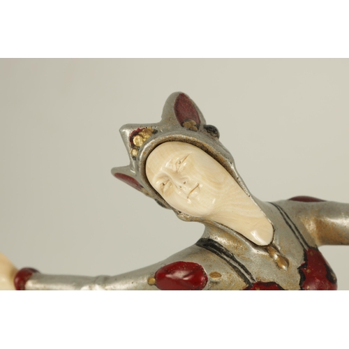 704 - AN ART DECO COLD PAINTED BRONZE AND IVORY FIGURE OF A FEMALE JESTER dancing and mounted on a stepped... 