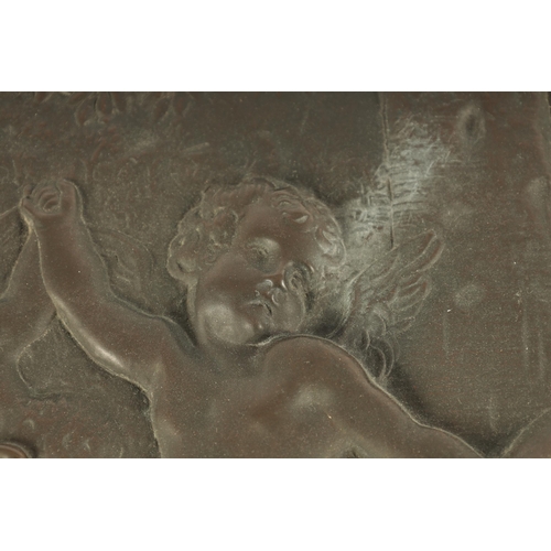 724 - A 19TH CENTURY FRENCH PATINATED BRONZE OVAL PLAQUE OF LARGE SIZE depicting cherubs in a dancing purs... 