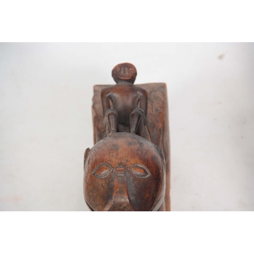 725 - AN UNUSUAL PAIR OF 19TH CENTURY CARVED AFRICAN COLUMNS of serpent shape with figural mounted tops (8... 