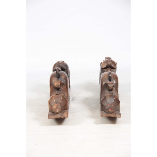 725 - AN UNUSUAL PAIR OF 19TH CENTURY CARVED AFRICAN COLUMNS of serpent shape with figural mounted tops (8... 