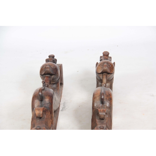 725 - AN UNUSUAL PAIR OF 19TH CENTURY CARVED AFRICAN COLUMNS of serpent shape with figural mounted tops (8... 