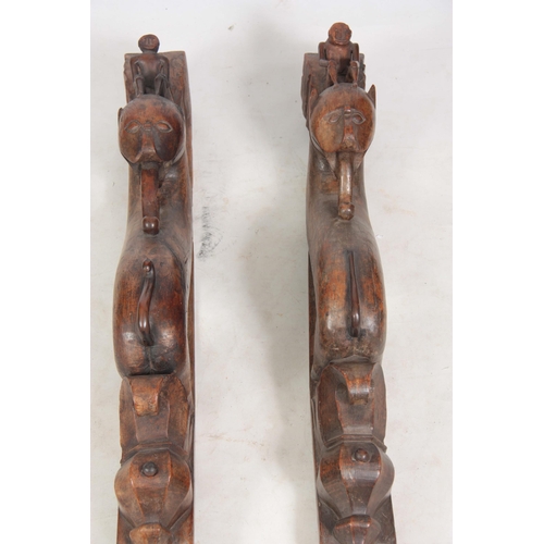 725 - AN UNUSUAL PAIR OF 19TH CENTURY CARVED AFRICAN COLUMNS of serpent shape with figural mounted tops (8... 