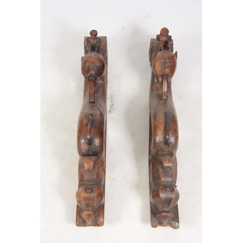 725 - AN UNUSUAL PAIR OF 19TH CENTURY CARVED AFRICAN COLUMNS of serpent shape with figural mounted tops (8... 