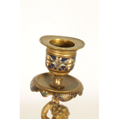 729 - A PAIR OF 19TH CENTURY FRENCH FIGURAL GILT BRONZE AND CHAMPLEVE ENAMEL CANDLESTICKS modelled as two ... 