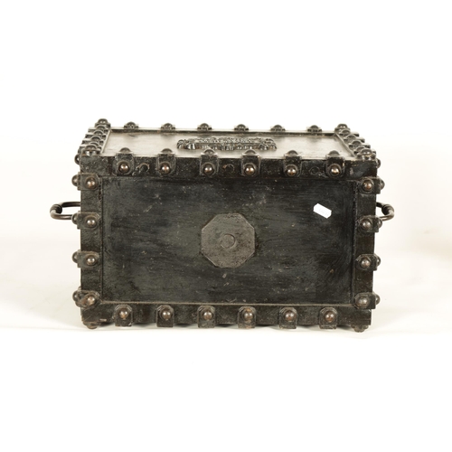 734 - A 19TH CENTURY CAST IRON STRONG BOX with riveted body and coat of arms to the front - in working con... 