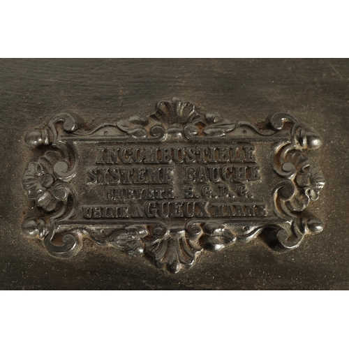 734 - A 19TH CENTURY CAST IRON STRONG BOX with riveted body and coat of arms to the front - in working con... 