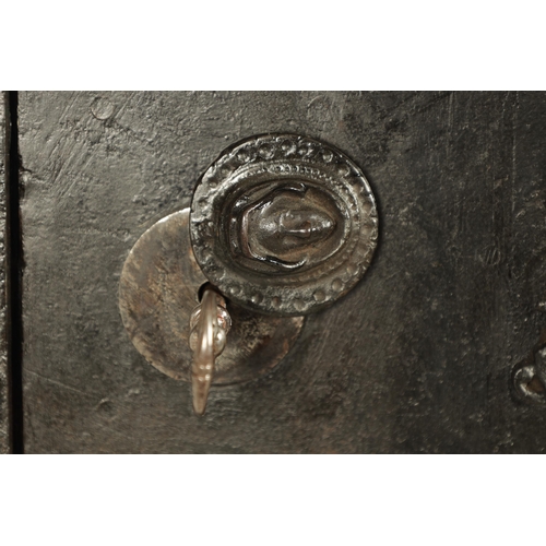 734 - A 19TH CENTURY CAST IRON STRONG BOX with riveted body and coat of arms to the front - in working con... 